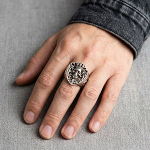 Red CZ Crowned Skull Sterling Silver Ring worn on an adult hand.