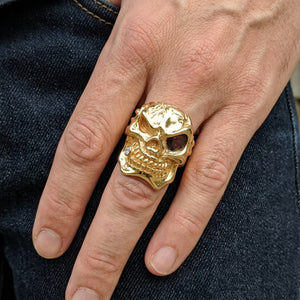 Red Eye Gold-Plated Sterling Silver Skull Ring, worn on an adult model