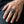 Red CZ Owl Sterling Silver Ring, worn on one middle finger in a natural hand close-up