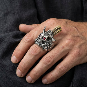 Red eye pirate skull silver ring worn on a hand