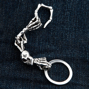 Red-Eye Skeleton Skull Sterling Silver Keychain showing the articulated skeletal sections arranged in a curve.