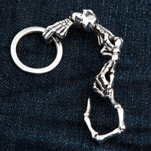 Red-Eye Skeleton Skull Sterling Silver Keychain showing reverse skull and skeletal joints in a curved layout.