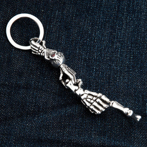 Red-Eye Skeleton Skull Sterling Silver Keychain showing the backs of the skull and skeletal hands laid straight.