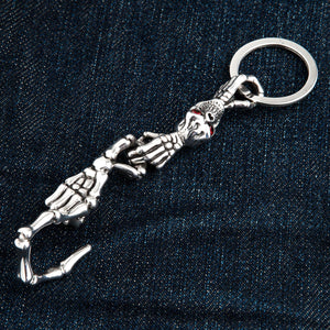 Red-Eye Skeleton Skull Sterling Silver Keychain showing the skull, hands and bone hook seen from the opposite angle.