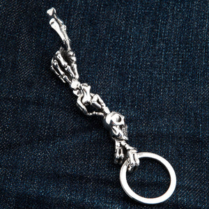 Red-Eye Skeleton Skull Sterling Silver Keychain showing straightened skeletal hands between hook and ring.