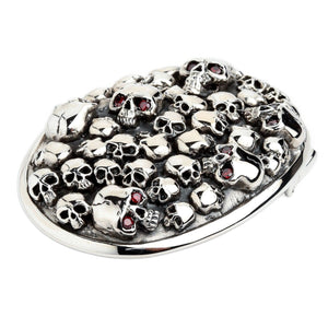 Red-Eye Skull Pile Sterling Silver Belt Buckle showing red eye accents and polished skulls at an oblique angle.