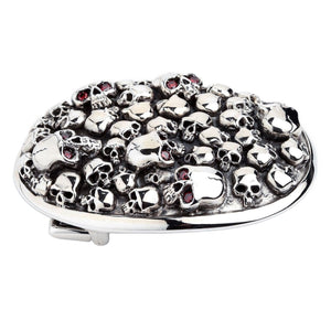 Red-Eye Skull Pile Sterling Silver Belt Buckle showing raised skull relief and smooth oval rim from a low angle.