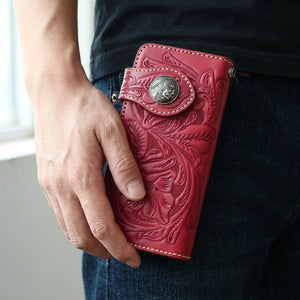 Red Indian Head Floral Leather Biker Wallet, held at hip level
