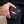 Red Stingray Cross Black Bifold Wallet, held in hand