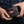 Red stingray cross bifold wallet held in hands