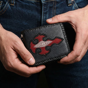Red stingray cross bifold wallet held in hands