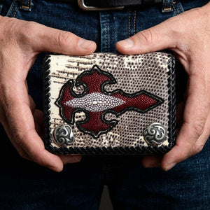 Red stingray cross monitor lizard wallet held in hands