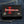 Red Stingray Cross Shark Leather Trifold Wallet, closed front on denim