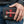 Red Stingray Cross Shark Leather Trifold Wallet, held in hand