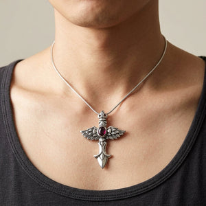 Red Stone Winged Cross Sterling Silver Pendant, worn on an adult model