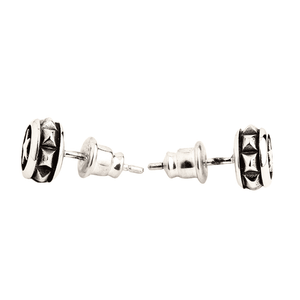 Round Star Stud Earrings in Sterling Silver. The studs lie facing opposite directions, revealing their ridged edges and posts.