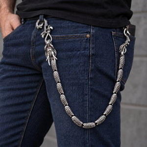 Ruby-eye sterling silver dragon wallet chain with thirteen scale links draped from a model's belt to a wallet
