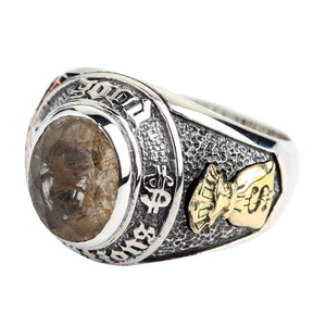 Opposite shoulder of the quartz ring with a brass money-bag detail