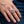 Sterling zilveren ring met schedel, gekruiste beenderen en schrift, gedragen aan de hand