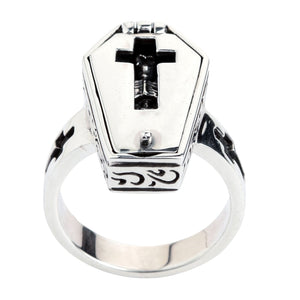 Front angle of the raised coffin case, polished lid and dark cross-shaped window.