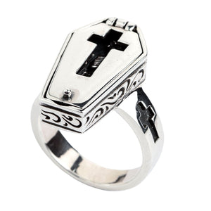 Side angle showing the polished coffin lid, scrollwork on the case and cross-shaped band opening.