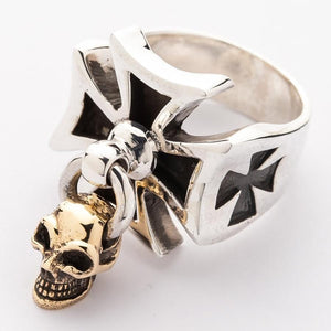 Angled view of the silver ring showing the smaller black shoulder cross beside the skull charm.