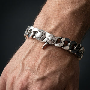 Heavy sterling silver curb bracelet worn on a wrist, showing the closed round-end clasp