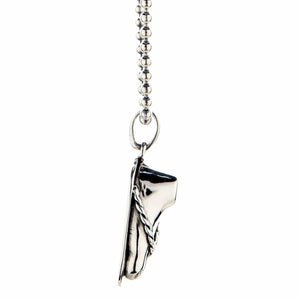 Sandaalvoet-hanger van 925 sterling zilver. Het smalle zijprofiel toont de verhoogde enkel en het zilveren sandaalbandje.
