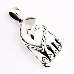 Sandaalvoet-hanger van 925 sterling zilver. De schuin geplaatste voet toont afgeronde tenen en het gekruiste sandaalbandje.