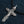 Skull Crucifix Sterling Silver Pendant with Garnet Eyes, angled denim view