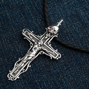 Skull Crucifix Sterling Silver Pendant with Garnet Eyes, angled denim view