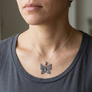Skull Butterfly Sterling Silver Gothic Pendant worn at an adult neckline