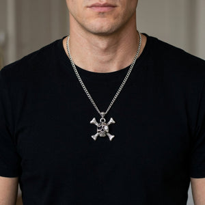 Skull-and-crossbones silver pendant on a 3 mm silver chain over a black shirt; chain shown for styling, listed cord is black leather