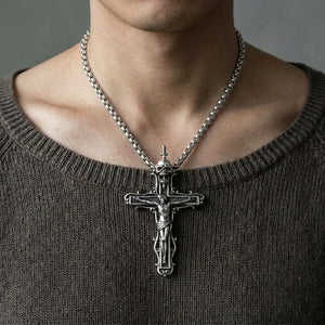Skull crucifix sterling silver pendant with garnet eyes worn on a 4 mm sterling silver chain