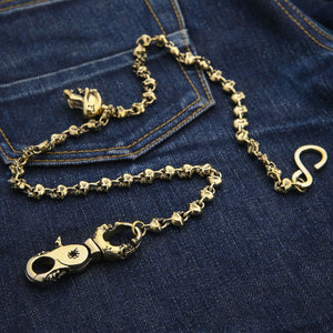 Catena da portafoglio in ottone Skull-Link, disposizione diagonale della catena e ciondolo a teschio su denim