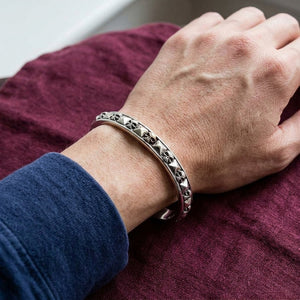 Skull and Pyramid Sterling Silver Cuff Bracelet worn on an adult wrist.