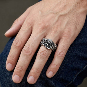 Skull and Rose Sterling Silver Ring, worn on one middle finger in a natural hand close-up
