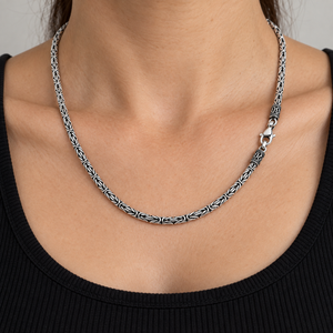 3mm Byzantine Sterling Silver Chain Necklace draped around the neckline of a black ribbed shirt.
