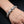 Snake-scale sterling silver bracelet worn on a wrist, showing raised scales and smooth connecting links.