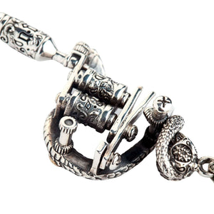 Snake and Skull Tattoo Machine Silver Pendant shown in coil and needle detail view.