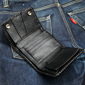 Open trifold showing the black cowhide card slots and inner fold.