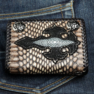Front of the snake wallet showing the stingray cross, pale pearl stripe and braided black edge.