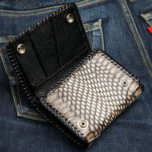 Snake trifold with its outer flap unsnapped, exposing the black lining and snap backs.