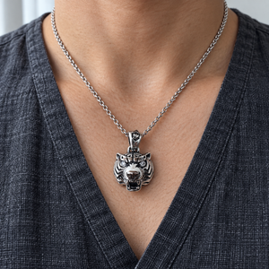 Clear CZ Tiger Head Sterling Silver Pendant on a silver styling chain over a charcoal shirt.
