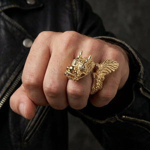 Solid 14k gold dragon ring with diamond eyes worn on hand for scale