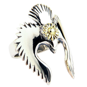 A Southwestern style ring featuring a polished silver bird with detailed feathers, shown at an angle.