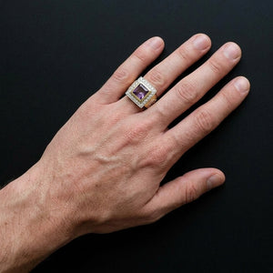 Square purple-stone gold-color bishop ring worn on an entire adult hand, with silver-color cross details