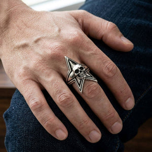 Star Skull Sterling Silver Statement Ring, worn on one middle finger in a natural hand close-up