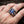 Gothic silver claw ring featuring a large rectangular blue sapphire gemstone gripped by dragon talons, worn on a man's finger