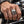 Sterling silver fang devil clear CZ ring worn on a natural hand gripping a motorcycle handlebar